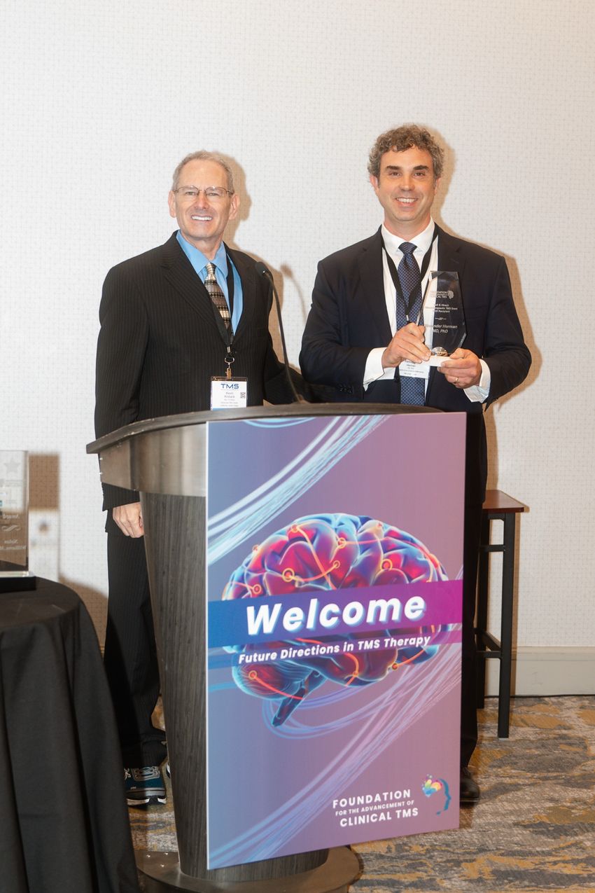 Alexander Herman, MD, PhD, receiving the 2025 Neil S. Hirsch Neurotherapeutic TMS Grant